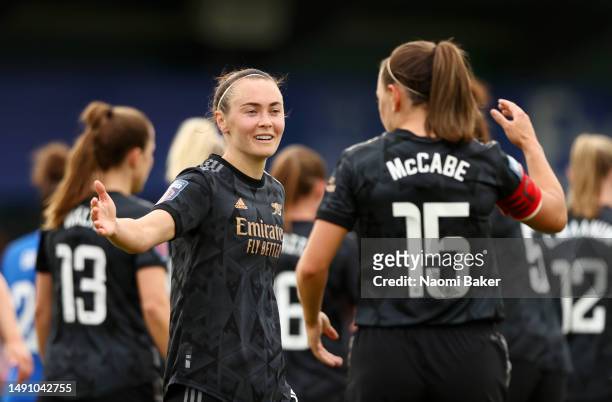 Caitlin Foord of Arsenal celebrates with teammate Katie McCabe after scoring the team's third goal during the FA Women's Super League match between...
