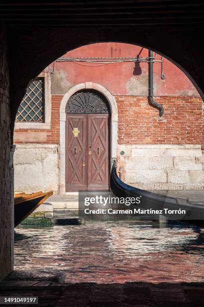 a canal-side alley in venice, italy. - bell tower tower stock pictures, royalty-free photos & images