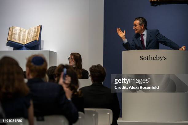 Auctioneer Benjamin Doller, takes bids for The Codex Sassoon during the auction at Sotheby's on May 17 , 2023 in New York City. The codex, which was...