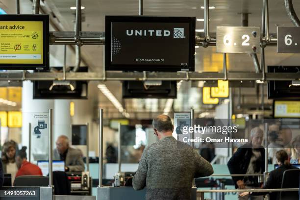 Passenger checks-in for a United Airlines flight at the Belgian capital's airport on May 17, 2023 in Brussels, Belgium. Brussels Airport is the main...