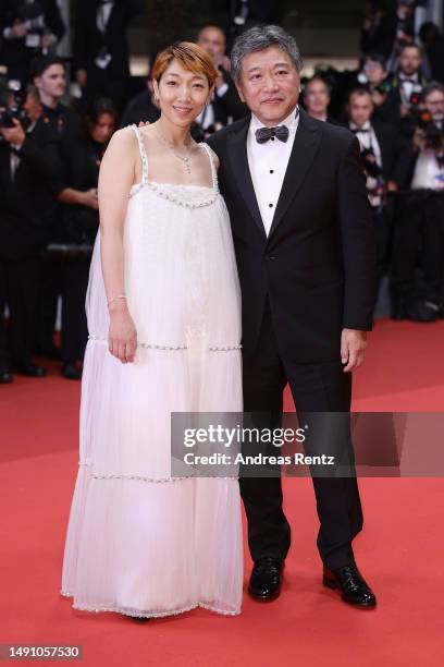 Sakura Andō and Director Hirokazu Kore-eda departs the "Monster" red carpet during the 76th annual Cannes film festival at Palais des Festivals on...