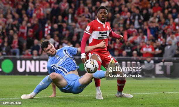 Coventry player Luke McNally challenges Chuba Akpom of Middlesbrough during the Sky Bet Championship Play-Off Semi-Final Second Leg match between...