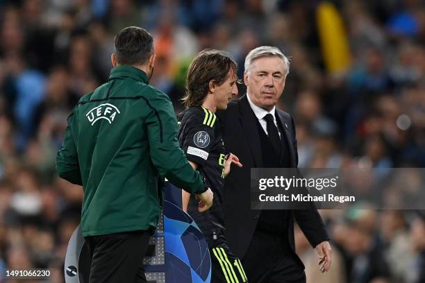 Luka Modric embraces Carlo Ancelotti, Head Coach of Real Madrid, after being substituted off during the UEFA Champions League semi-final second leg...