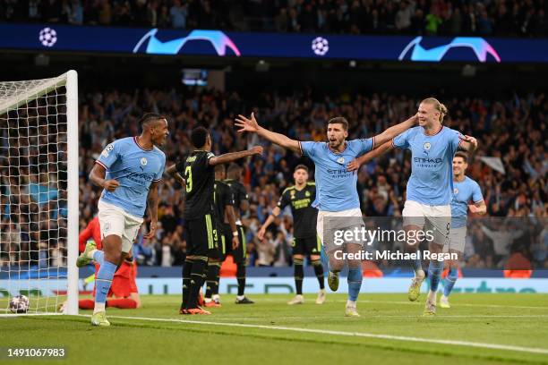 Manuel Akanji celebrates with Erling Haaland of Manchester City after an own goal by Eder Militao of Real Madrid Manchester City's third goal during...