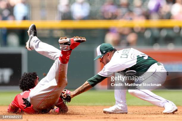 Jose Barrero of the Cincinnati Reds is tagged out trying to reach second base after hitting a RBI single by Harold Castro of the Colorado Rockies in...