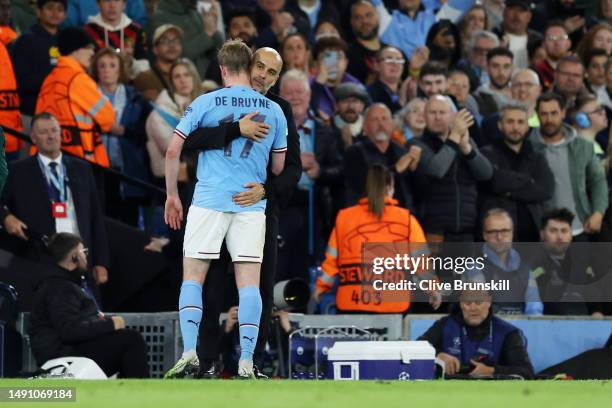 Pep Guardiola embraces Kevin De Bruyne of Manchester City as they are substituted off during the UEFA Champions League semi-final second leg match...