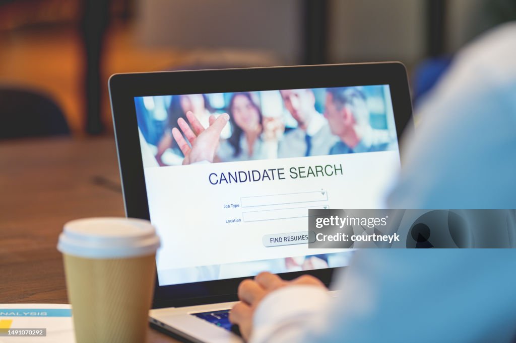 Businessman looking at recruitment website on a laptop computer
