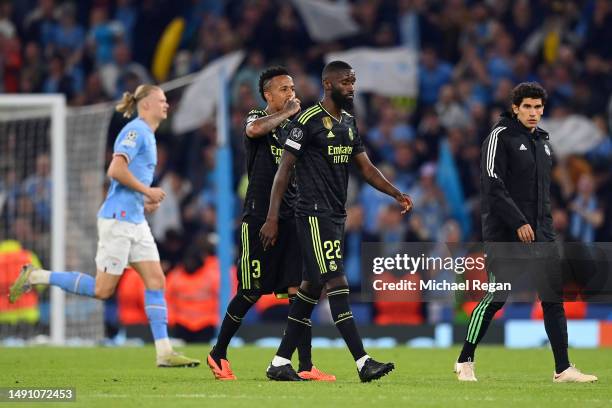 Eder Militao and Antonio Ruediger of Real Madrid look dejected following the team's defeat during the UEFA Champions League semi-final second leg...