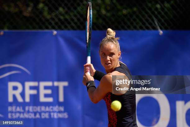 Arantxa Rus of Netherlands plays a backhand in her first round doubles match against Emily Appleton of Great Britain and Bibiane Schoofs of...