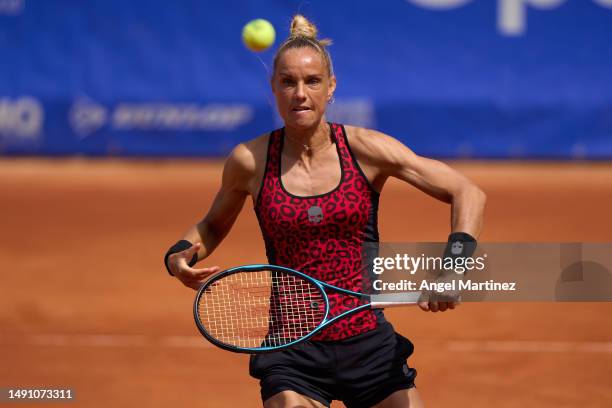 Arantxa Rus of Netherlands plays a backhand in her first round doubles match against Emily Appleton of Great Britain and Bibiane Schoofs of...