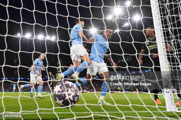 Manuel Akanji celebrates with Erling Haaland of Manchester City after an own goal by Eder Militao of Real Madrid Manchester City's third goal during...