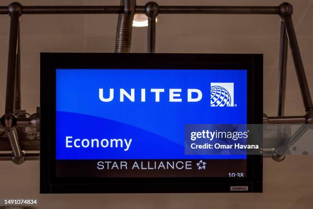 United Airlines economy class check-in screen is seen in the departures terminal of the airport of the Belgian capital on May 17, 2023 in Brussels,...