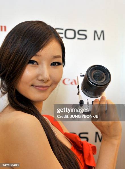 A South Korean model shows Canon's new mirrorless digital camera, EOS