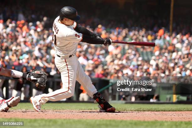 Wilmer Flores of the San Francisco Giants hits a single that scored two runs against the Philadelphia Phillies in the eighth inning at Oracle Park on...