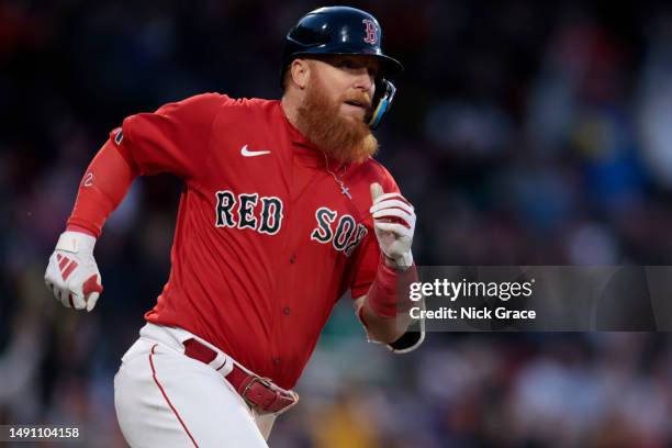 Justin Turner of the Boston Red Sox rounds the bases after hitting a home run during the second inning against the Seattle Mariners at Fenway Park on...