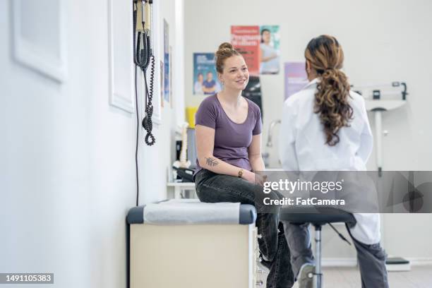 women's health appointment - young women stock pictures, royalty-free photos & images