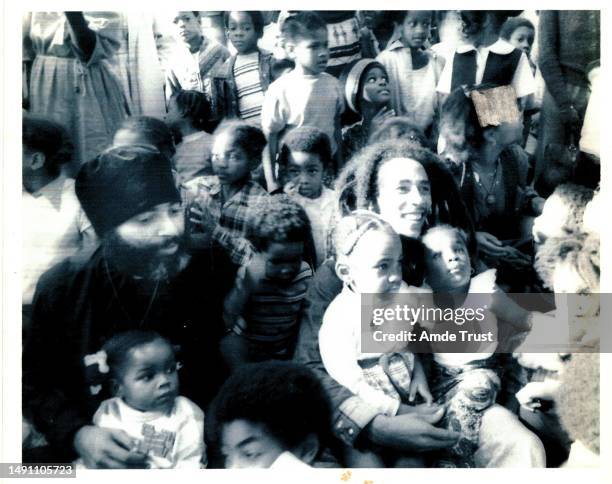 Fr. Amde Hamilton and reggae singer Bob Marley were surrounded by children at an event for Saint Tekle Haymonot Ethiopian Orthodox Church at the...