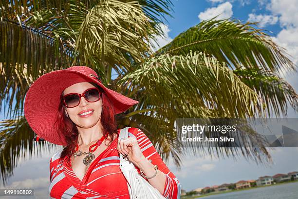 woman with red hair wearing red, smiling, portrait - ミラマー市 ストックフォトと画像