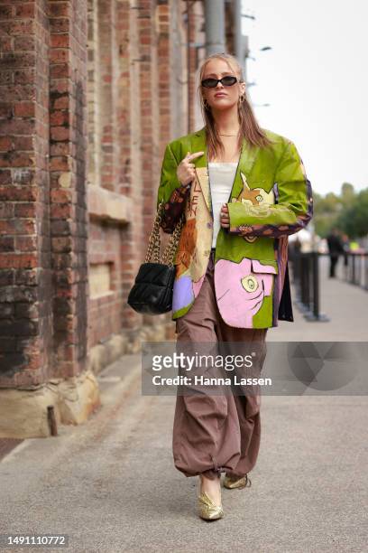 Guest wearing custom painted art jacket by M LAK at Afterpay Australian Fashion Week 2023 at Carriageworks on May 18, 2023 in Sydney, Australia.
