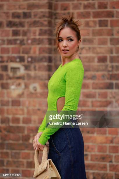 Olivia Molly Rogers wearing green cut off top and maxi denim skirt at Afterpay Australian Fashion Week 2023 at Carriageworks on May 18, 2023 in...