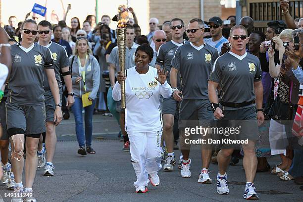 Doreen Lawrence, mother of murdered teenager Stephen Lawrence, carries the Olympic Torch into the Stephen Lawrence Charitable Trust Centre for the...
