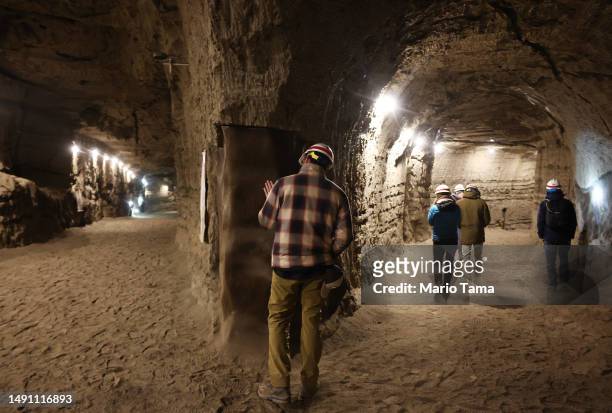 In this image released on May 17 NASA SnowEx campaign researchers and pilots tour the Permafrost Tunnel Research Facility, which contains 18,000 to...