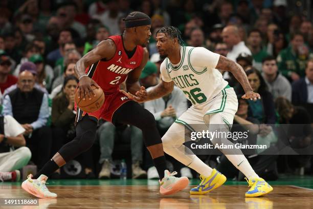 Jimmy Butler of the Miami Heat is defended by Marcus Smart of the Boston Celtics during the first quarter of game one of the Eastern Conference...