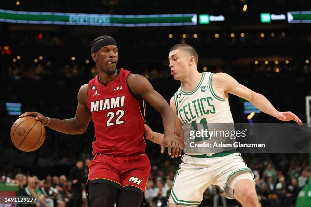 Jimmy Butler of the Miami Heat is defended by Payton Pritchard of the Boston Celtics during the third quarter of game one of the Eastern Conference...