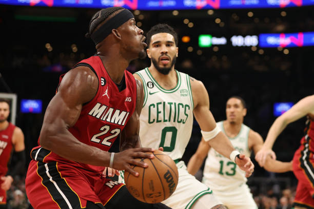 Jimmy Butler of the Miami Heat is defended by Jayson Tatum of the Boston Celtics during the third quarter of game one of the Eastern Conference...