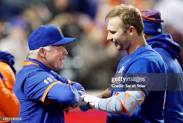 Pete Alonso reacts with manager Buck Showalter of the New York Mets after hitting a walk-off three-run home run during the tenth inning against the...