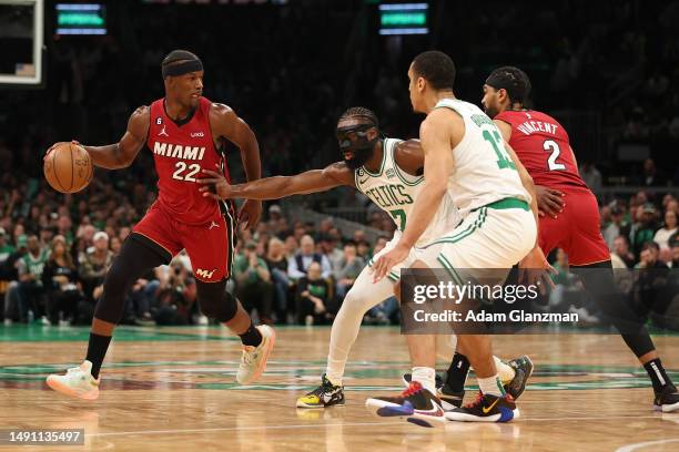 Jimmy Butler of the Miami Heat is defended by Jaylen Brown of the Boston Celtics during the fourth quarter of game one of the Eastern Conference...