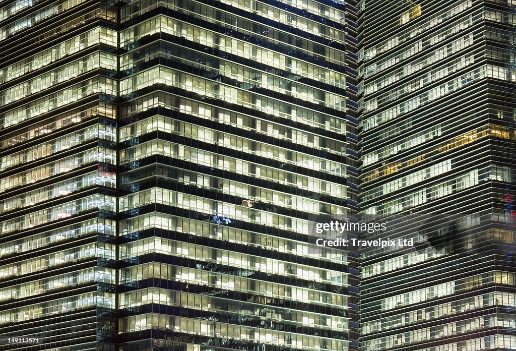 Working late, office block windows, Singapore