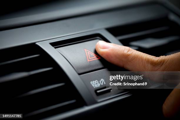 car emergency light button man pushing red triangle warning car button - luz de emergencia fotografías e imágenes de stock