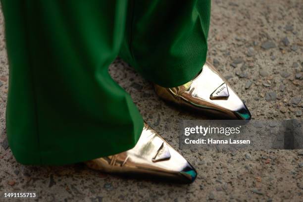 Katya Komarova, shoe detail, wearing green suit, Prada gold shoes at Afterpay Australian Fashion Week 2023 at Carriageworks on May 18, 2023 in...