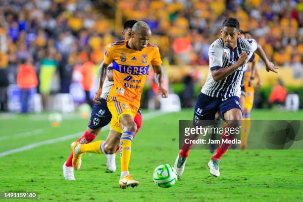 Luis Quinones of Tigres fights for the ball with Luis Romo of Monterrey during the semifinal first leg match between Tigres UANL and Monterrey as...