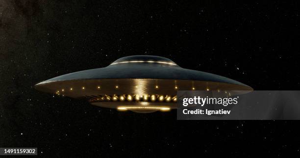 ufo hovering in space against the cosmos - alien arrival stock pictures, royalty-free photos & images