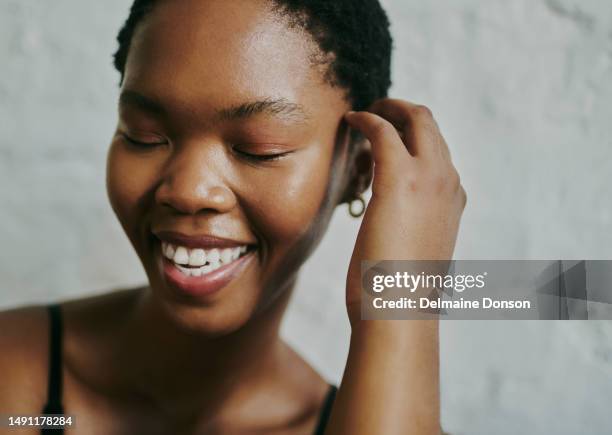 close up shot of a beautiful black woman, smiling with her eyes closed. stock photo - dark skin tone stock pictures, royalty-free photos & images