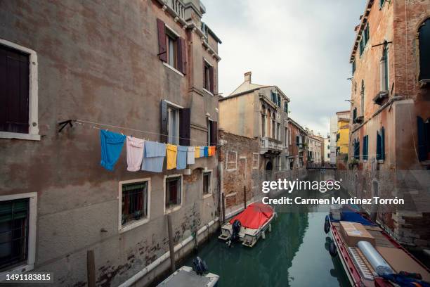 clothes drying on old building window. architecture of venice. typical venice streets, italy. - wonder film 2017 stockfoto's en -beelden