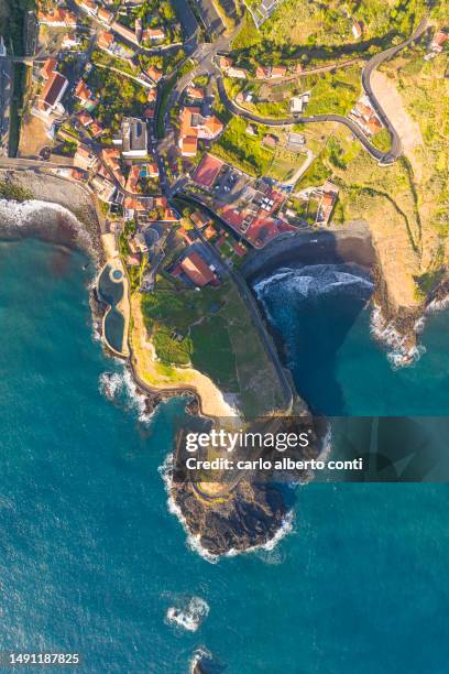 aerial view taken by drone of the little touristic village of porto da cruz during a sunny spring day, madeira, portugal, europe - cruz stock pictures, royalty-free photos & images