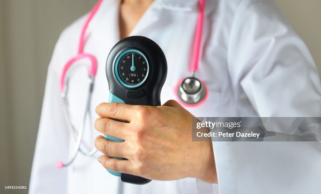 NHS doctor with hand grip tester