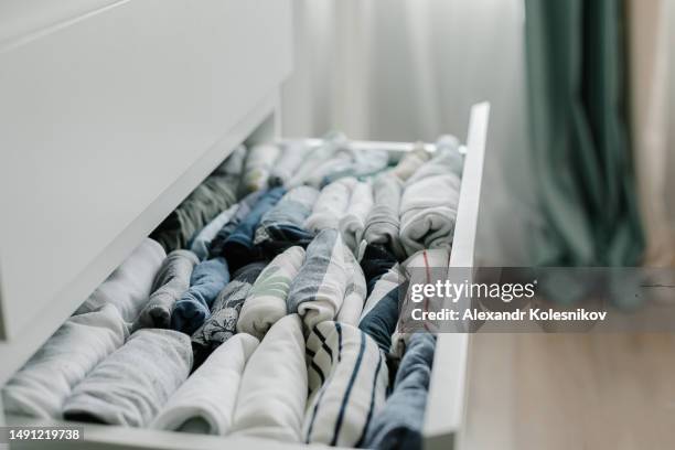 open drawer with kids t-shirts. vertical storage of clothing - drawer stock pictures, royalty-free photos & images