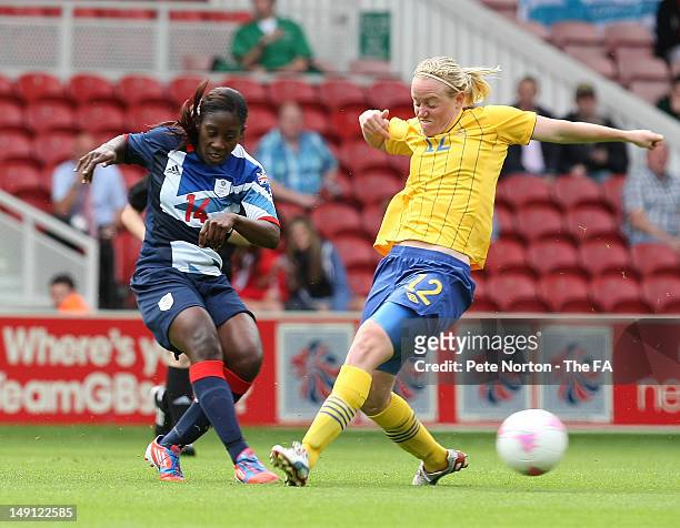 Anita Asante of Team GB plays the ball past Marie Hammarstrom of Sweden during the International Friendly match between Team GB Women and Sweden...
