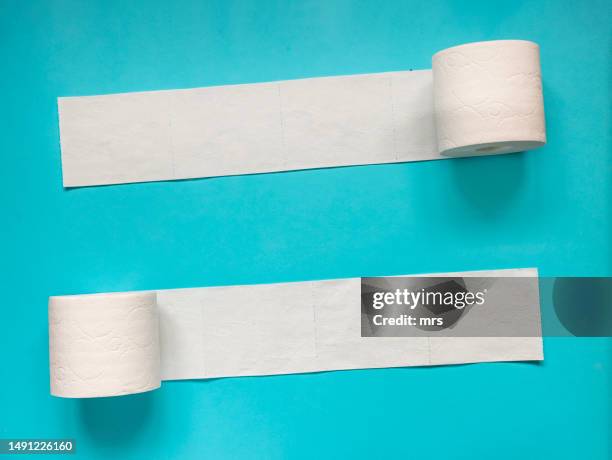 toilet paper on blue background - toilet paper stock pictures, royalty-free photos & images