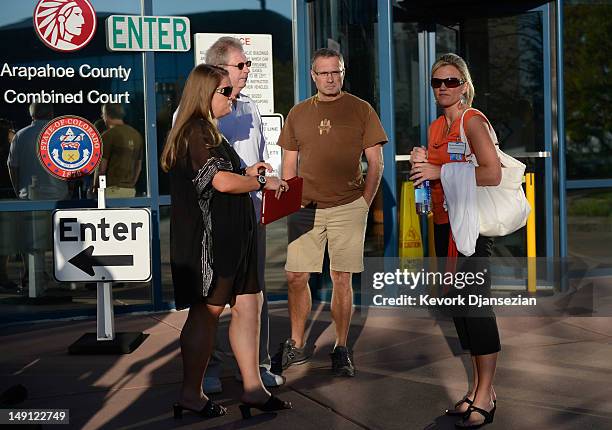 Family members and their representatives wait to enter the Arapahoe County Courthouse for the first court hearing for alleged Century 16 movie...