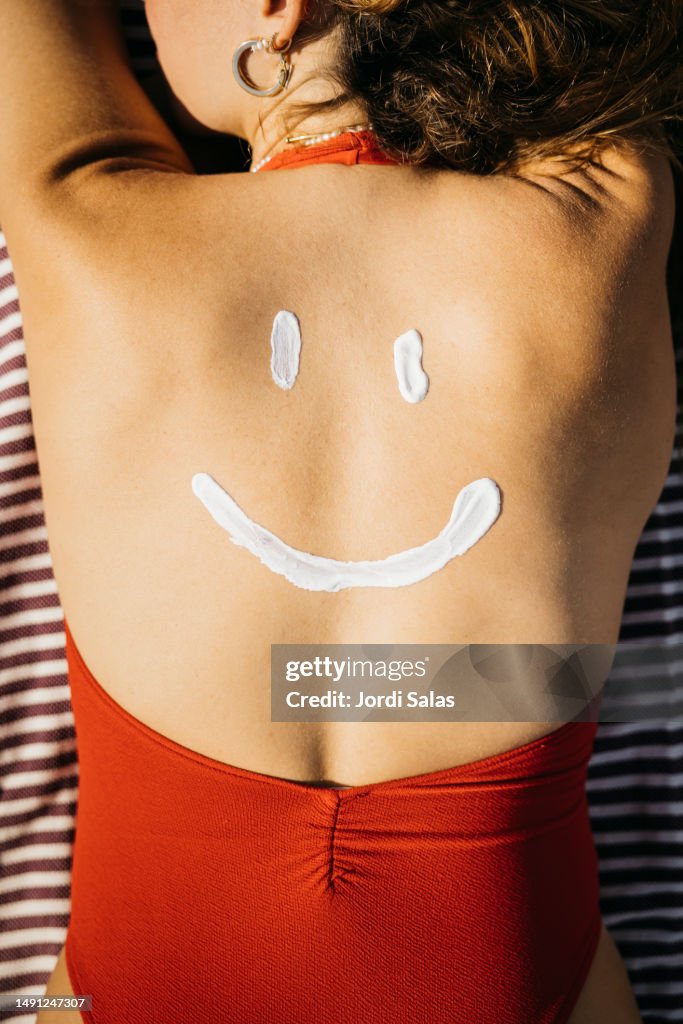 Suntan lotion on a woman's back