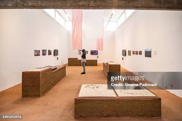 Visitors attend the press preview at the Brazilian pavilion "Terra [Earth]" curated by Gabriela de Matos e Paulo Tavares and with the exhibitors Ana...