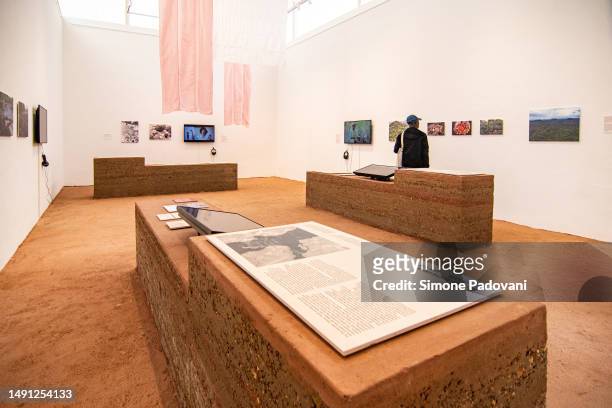 Visitors attend the press preview at the Brazilian pavilion "Terra [Earth]" curated by Gabriela de Matos e Paulo Tavares and with the exhibitors Ana...