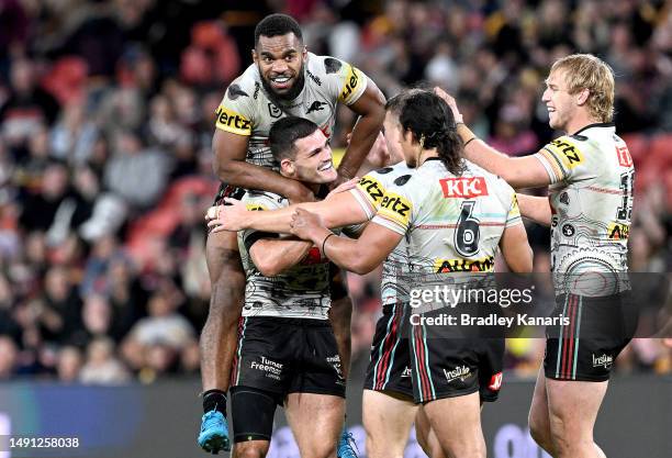 Nathan Cleary of the Panthers and his team mates celebrate victory after the round 12 NRL match between Brisbane Broncos and Penrith Panthers at...