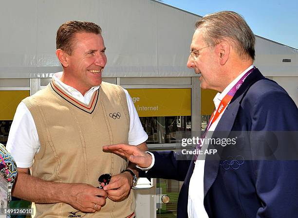 President of the International Olympic Committee Jacques Rogge chats with Ukrainian former pole vault champion Sergey Bubka during a visit at the...