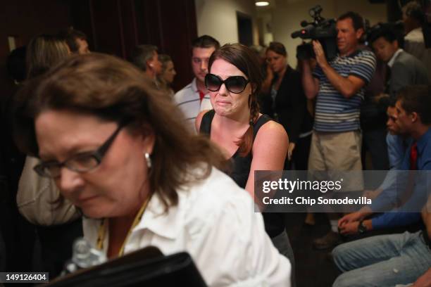 Families members of the victims of last Friday's movie theater mass shooting arrive at the Arapahoe County Courthouse for James Holmes' first court...